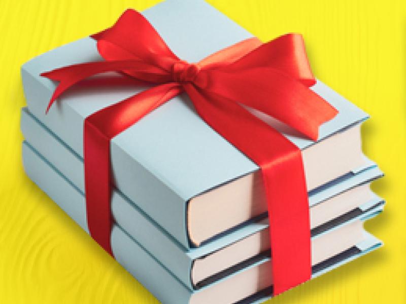 a stack of books tied with a red ribbon