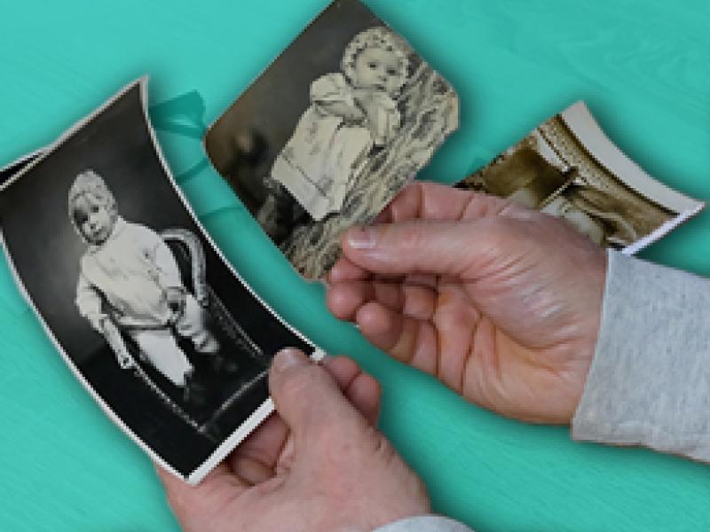 hands holding vintage photos of babies