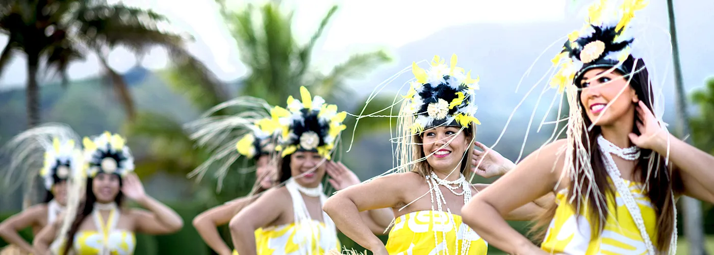 photo of Hawaiian women dancing in yellow traditional costumes